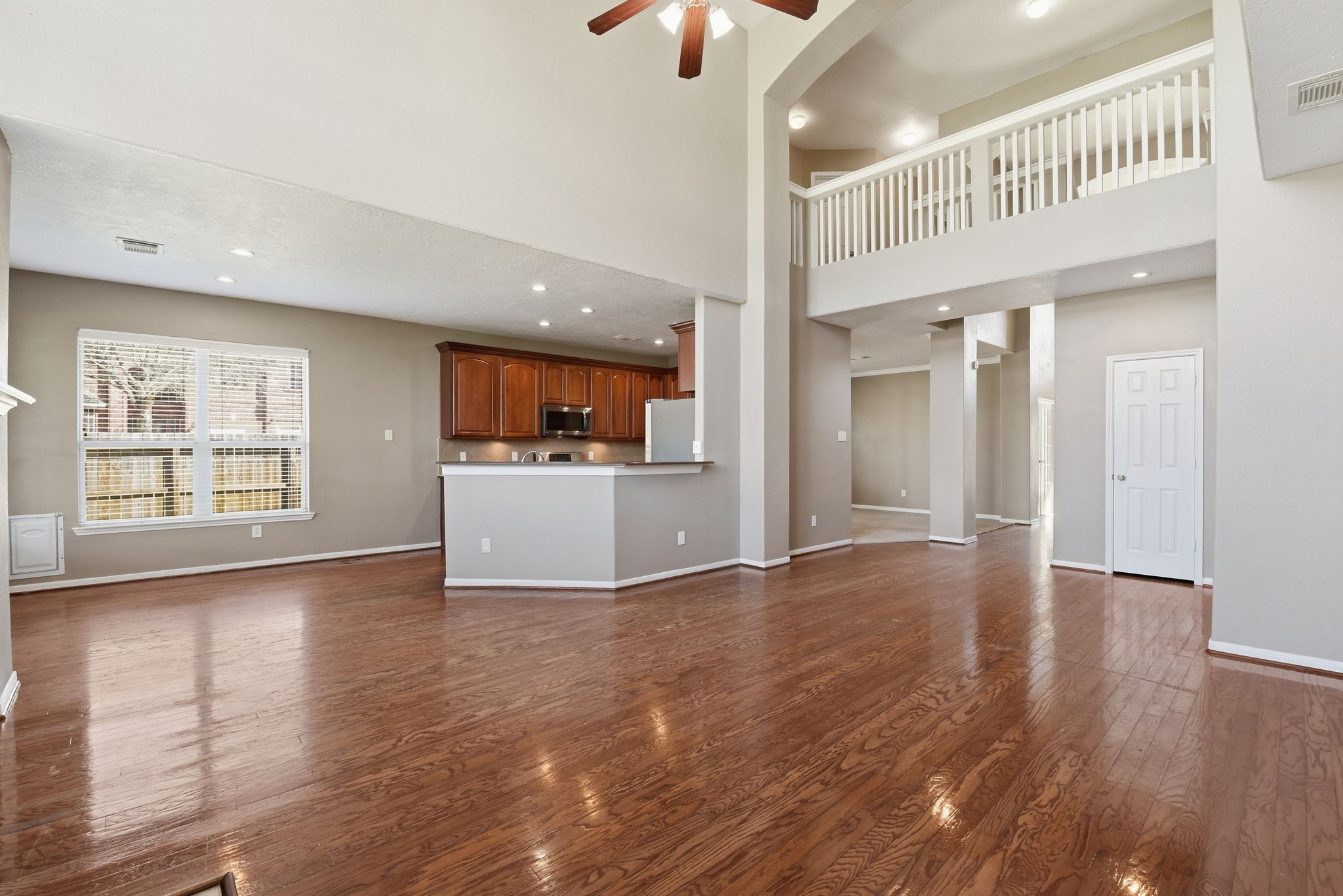 13902 Oneida Court Cypress, TX 77429 - Photo 22 of 48 a view of an empty room with a window and wooden floor