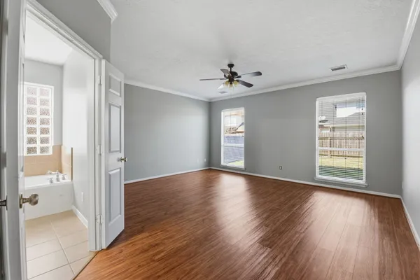 wooden floor in an empty room with a window