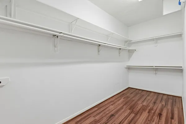 a view of a room with wooden floor