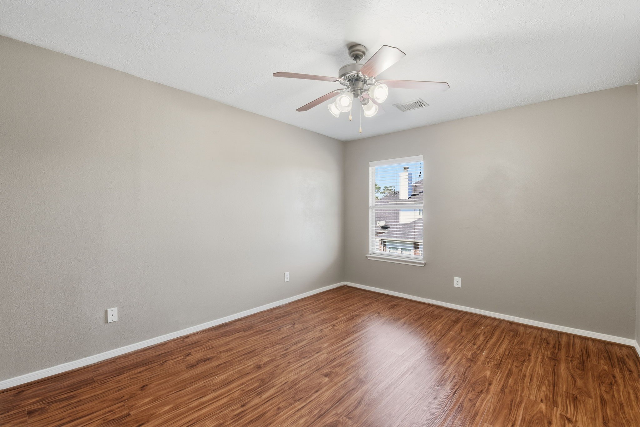 13902 Oneida Court Cypress, TX 77429 - Photo 41 of 48 a view of an empty room with wooden floor and a fan