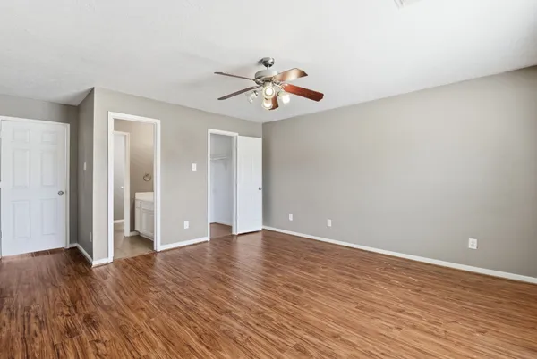 a view of an empty room with wooden floor