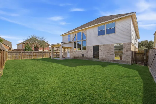 a view of a house with a backyard