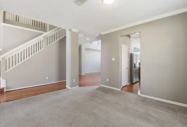 a view of an empty room with stairs