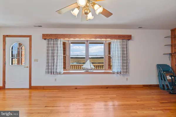 a kitchen that has a sink and a stove with white cabinets