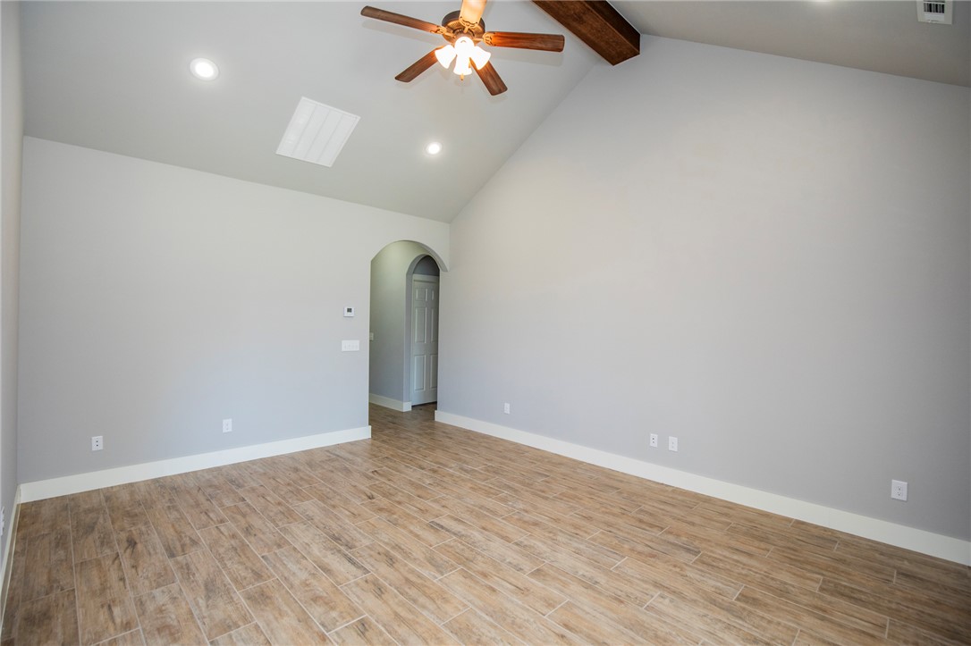 214 Alder Street Pea Ridge, AR 72751 - Photo 5 of 20 Vaulted ceiling featuring a dark wood beam, a ceiling fan, and recessed lighting
