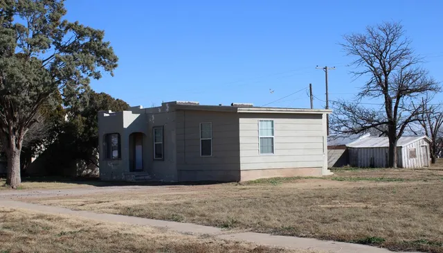 a view of a house with a yard and garage