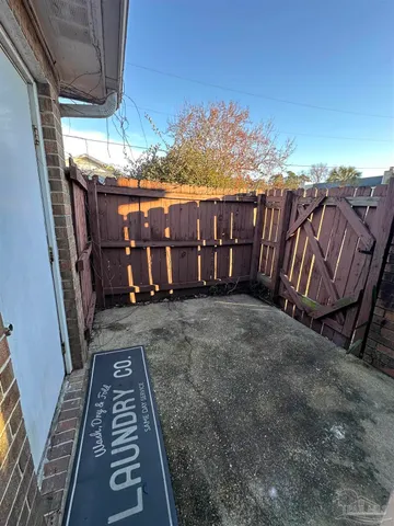 a view of a backyard with wooden fence
