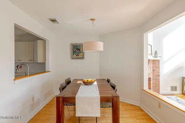 a view of a dining room with furniture and a window