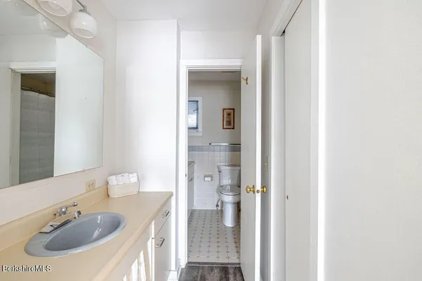 a en suite bathroom with a sink double vanity and a mirror