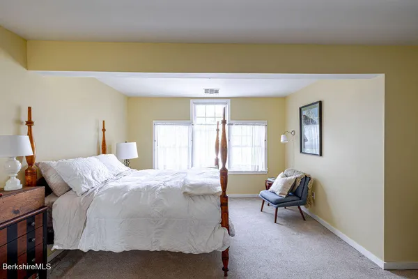 a bed room with a bed and a chair