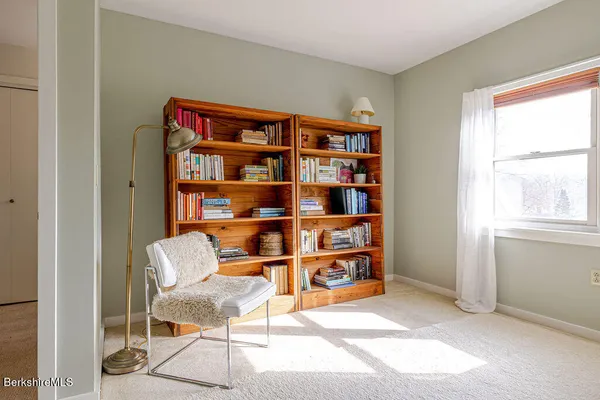 a bedroom with a bed and a chair