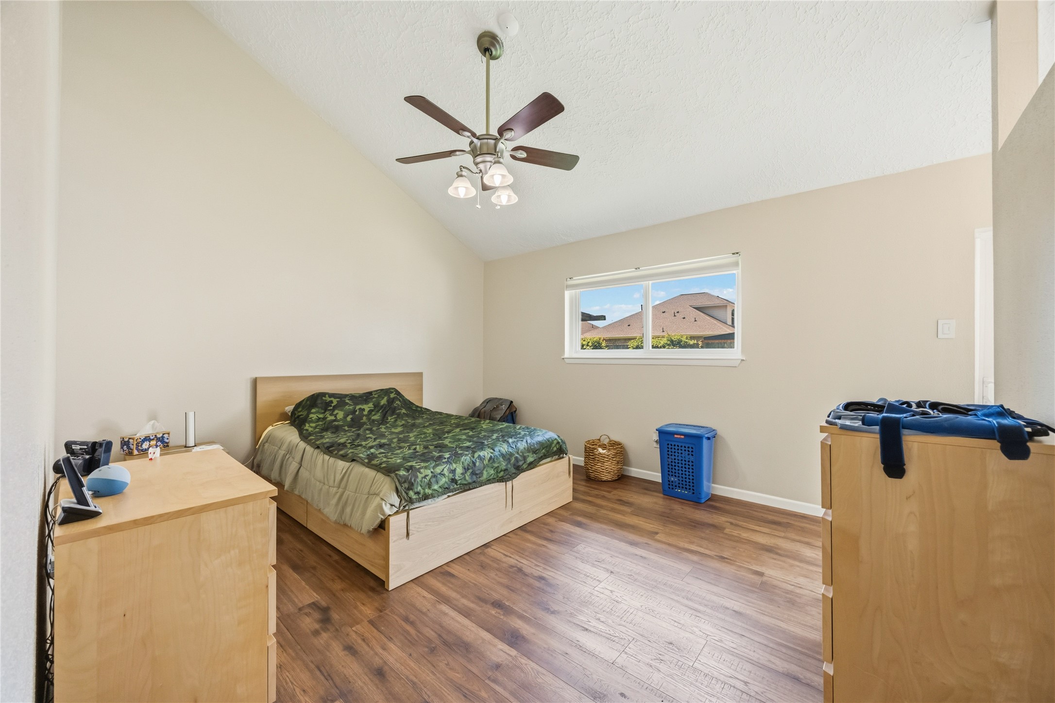 9635 Birsay Street Spring, TX 77379 - Photo 18 of 24 a bedroom with a bed and a chandelier