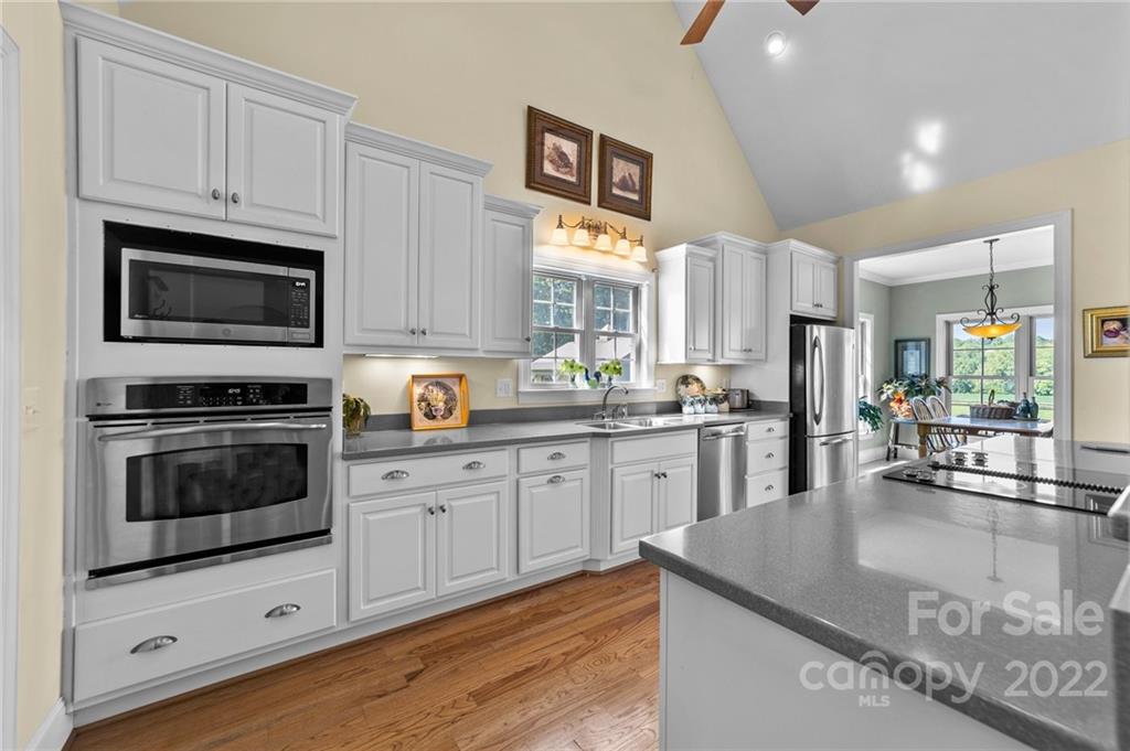 356 Greenhill Road Mocksville, NC 27028 - Photo 33 of 46 a kitchen with stainless steel appliances granite countertop a stove a sink and a microwave