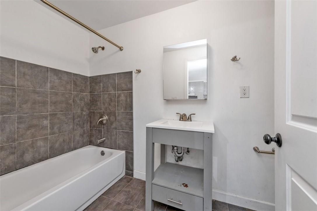 196 Decatur Street Brooklyn, NY 11233 - Photo 13 of 20 a bathroom with a sink a toilet and bathtub