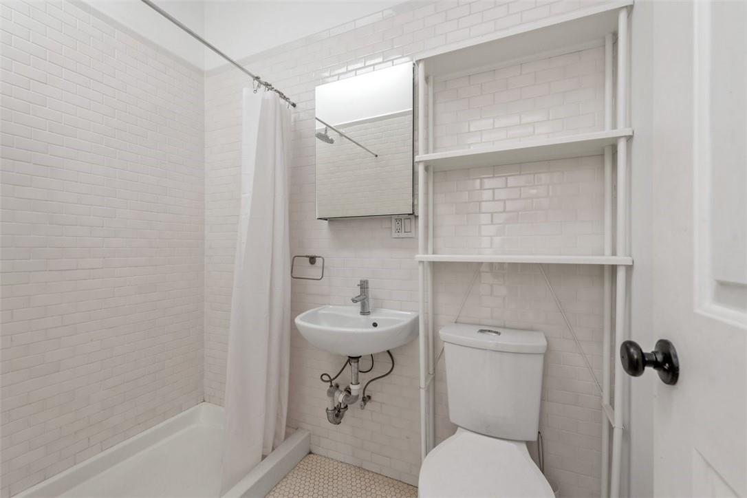 196 Decatur Street Brooklyn, NY 11233 - Photo 14 of 20 a bathroom with a sink a toilet and shower