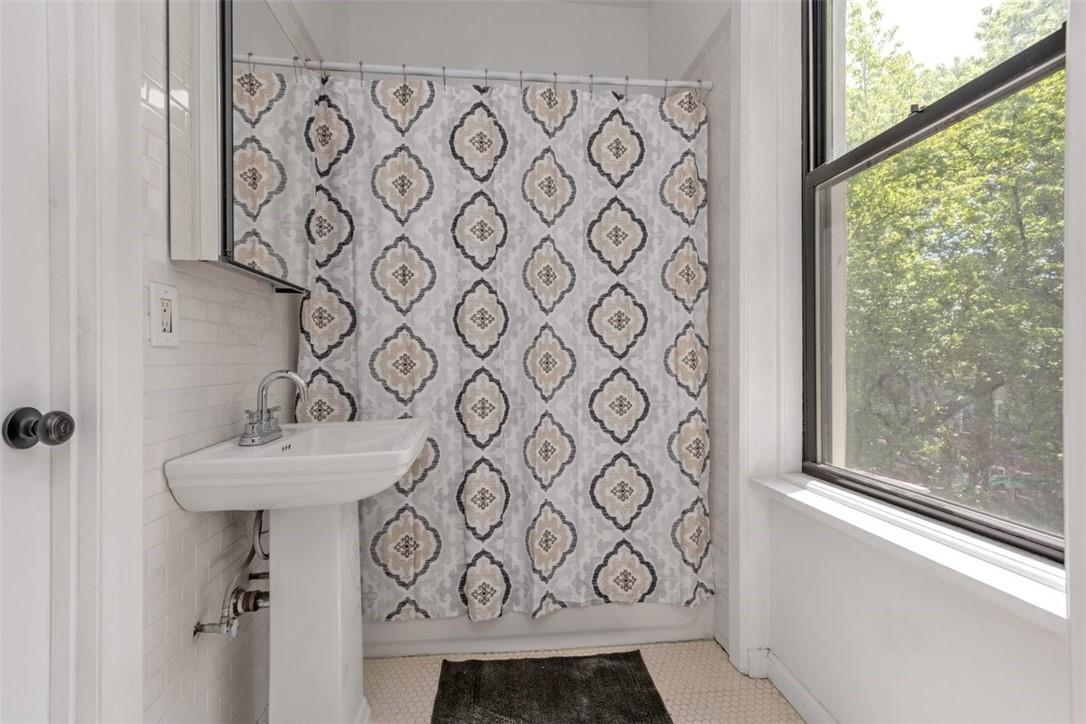 196 Decatur Street Brooklyn, NY 11233 - Photo 18 of 20 a bathroom with a sink and a mirror