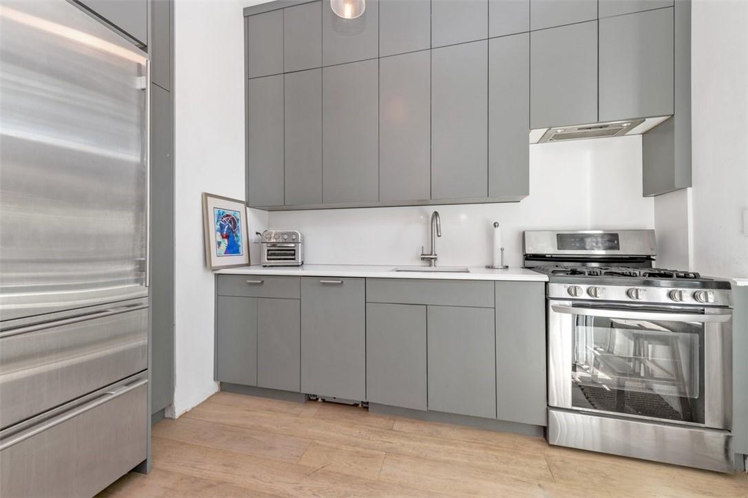 196 Decatur Street Brooklyn, NY 11233 - Photo 6 of 20 a kitchen with cabinets appliances and a sink