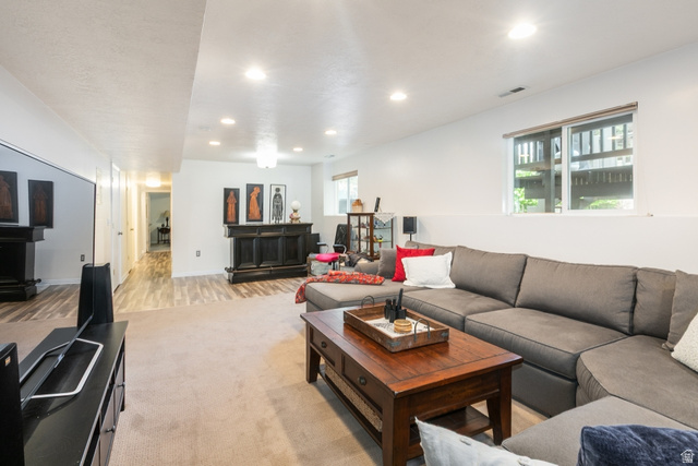 10183 Hickory Point Drive Sandy, UT 84092 - Photo 25 of 36 Spacious entertainment area featuring recessed lighting, a built-in bar, and wood-finish flooring