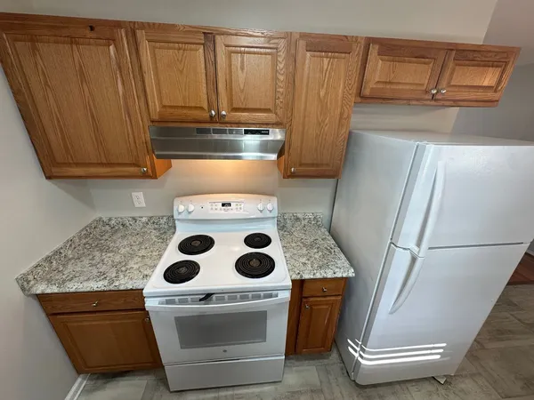 a stove top oven sitting inside of a kitchen