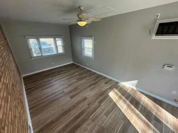 a view of a livingroom with a ceiling fan and window