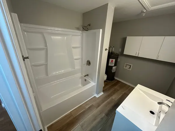 a bathroom with a tub and a sink