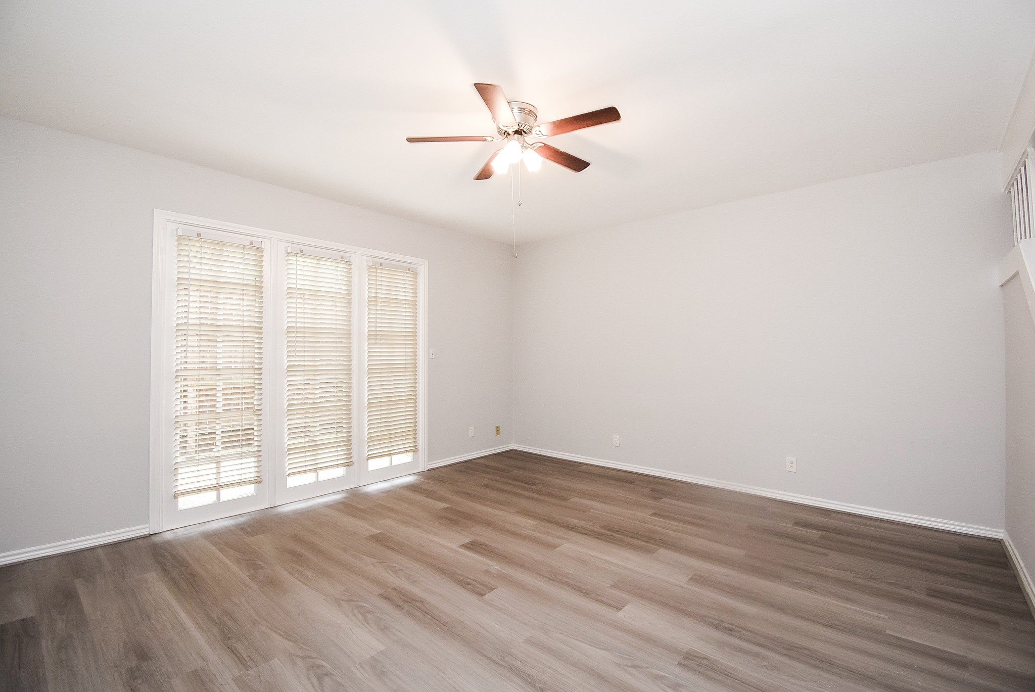 201 Vanderpool Lane, Unit 113 Houston, TX 77024 - Photo 8 of 45 wooden floor in an empty room with a window