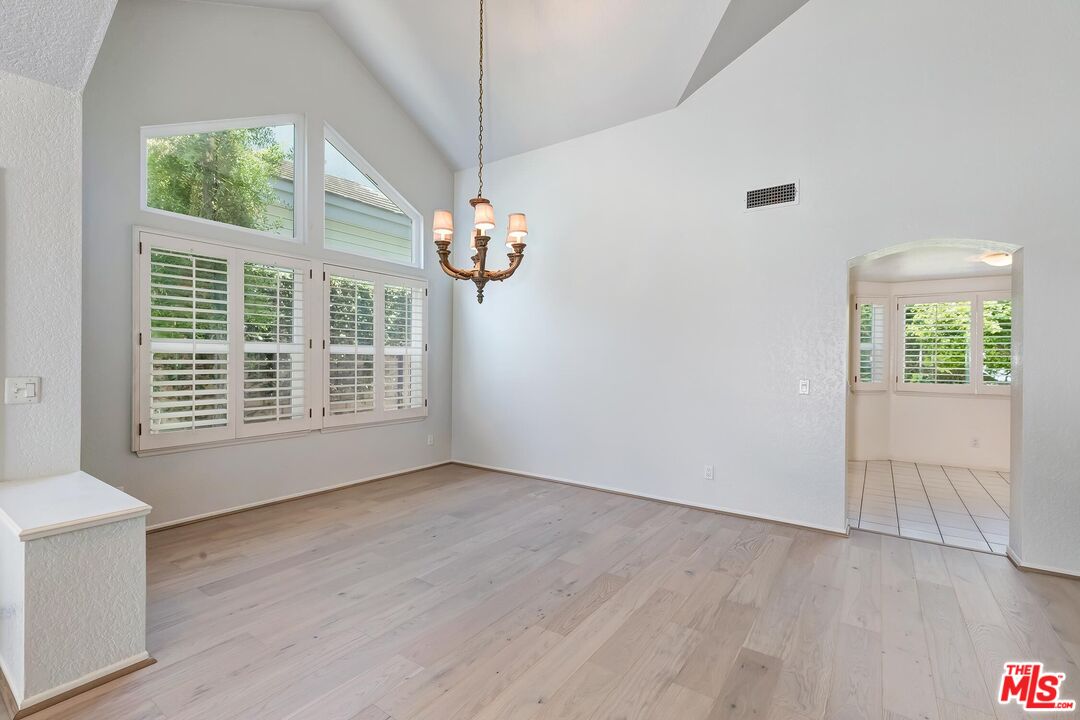 7557 West 82nd Street Playa del Rey, CA 90293 - Photo 11 of 35 a view of an empty room with wooden floor and a window