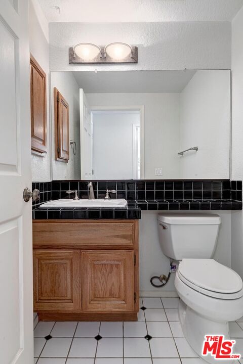7557 West 82nd Street Playa del Rey, CA 90293 - Photo 20 of 35 a bathroom with a toilet a sink and mirror