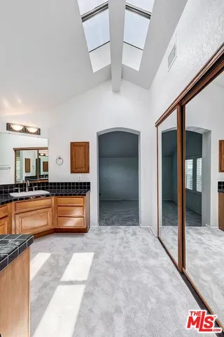 a kitchen with stainless steel appliances kitchen island granite countertop a sink and cabinets