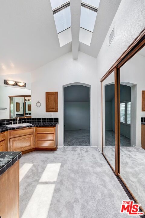7557 West 82nd Street Playa del Rey, CA 90293 - Photo 26 of 35 a kitchen with stainless steel appliances kitchen island granite countertop a sink and cabinets