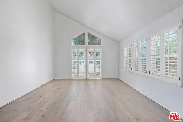 wooden floor in an empty room with a window