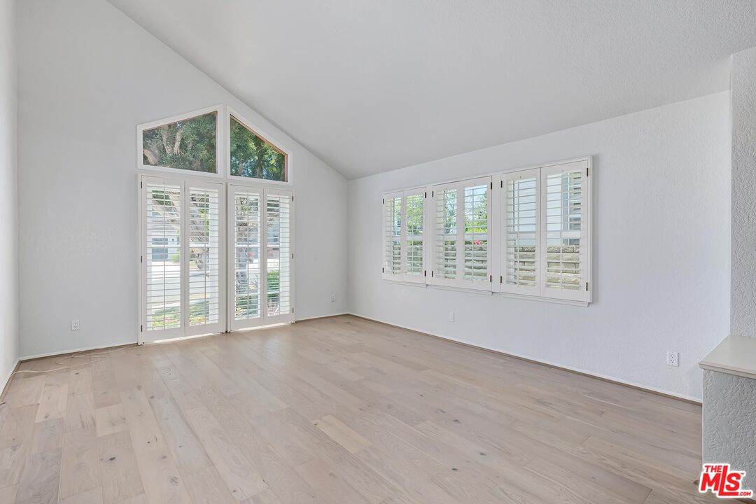 7557 West 82nd Street Playa del Rey, CA 90293 - Photo 8 of 35 an empty room with wooden floor and windows