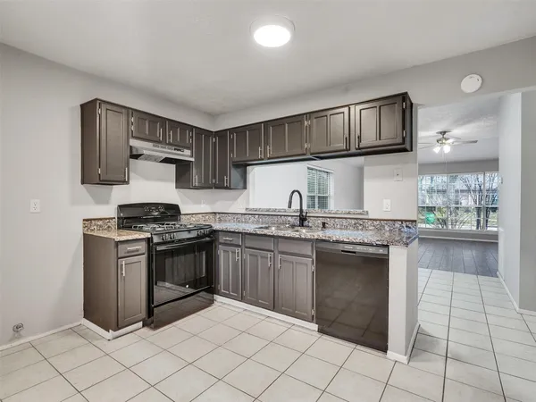 a kitchen with stainless steel appliances granite countertop a stove and a sink