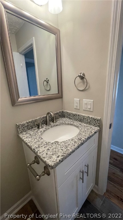7050 Faircloth Bridge Road Stedman, NC 28391 - Photo 16 of 21 a bathroom with a granite countertop sink and a mirror
