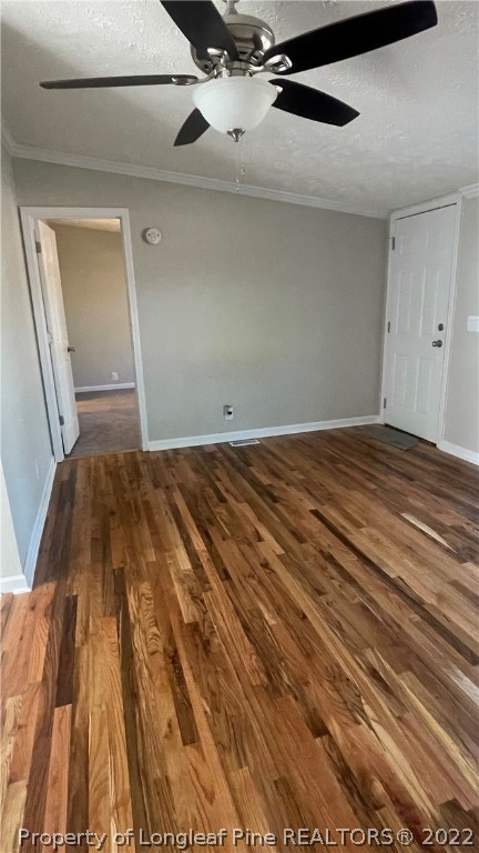 7050 Faircloth Bridge Road Stedman, NC 28391 - Photo 3 of 21 a view of a bedroom with wooden floor and ceiling fan