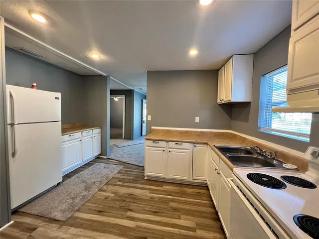 a view of a room with wooden floor