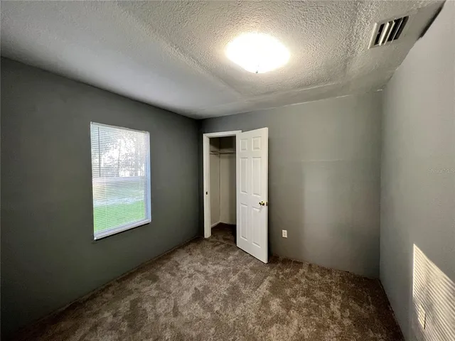 a view of an empty room and a window