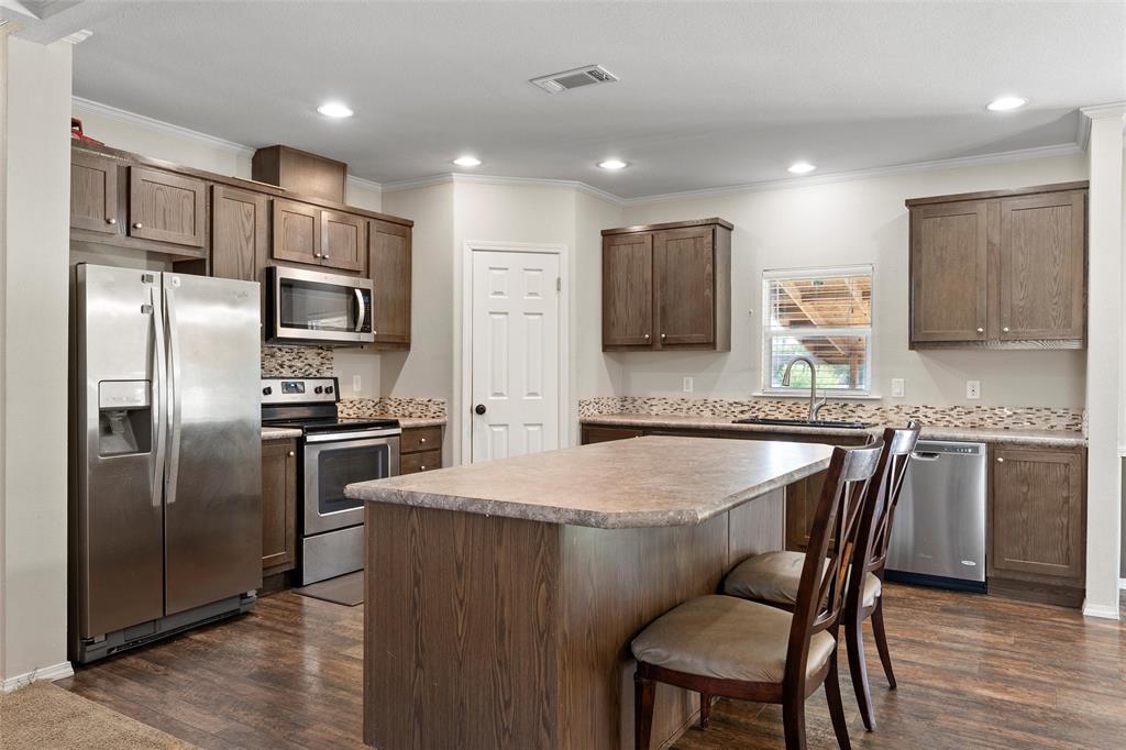 1605 Cloverleaf Road Bellmead, TX 76705 - Photo 12 of 29 a kitchen with stainless steel appliances granite countertop a refrigerator a stove a sink and a microwave