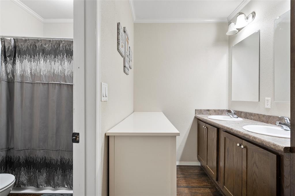 1605 Cloverleaf Road Bellmead, TX 76705 - Photo 20 of 29 a bathroom with a granite countertop sink a toilet and shower