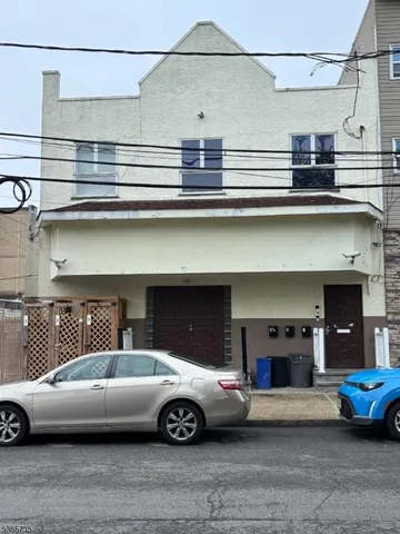 a front view of a house with parking space