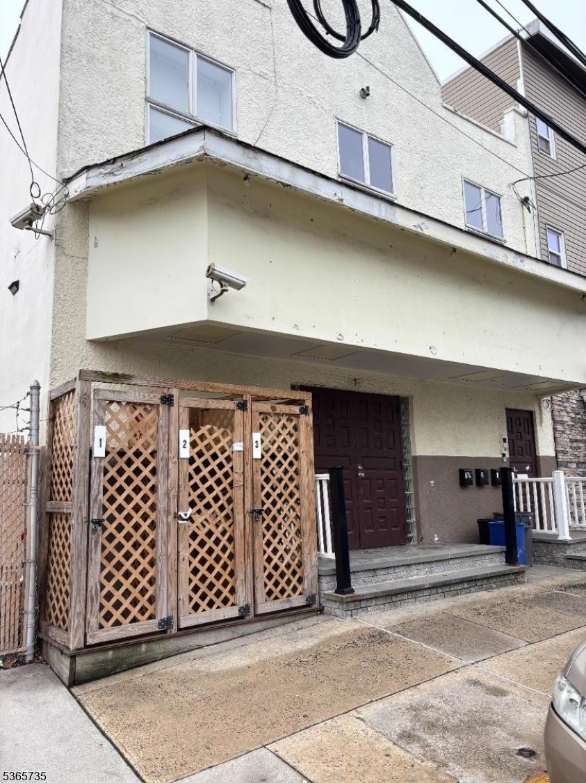 74 Walnut Street Newark, NJ 07102 - Photo 2 of 2 a front view of a building with entryway