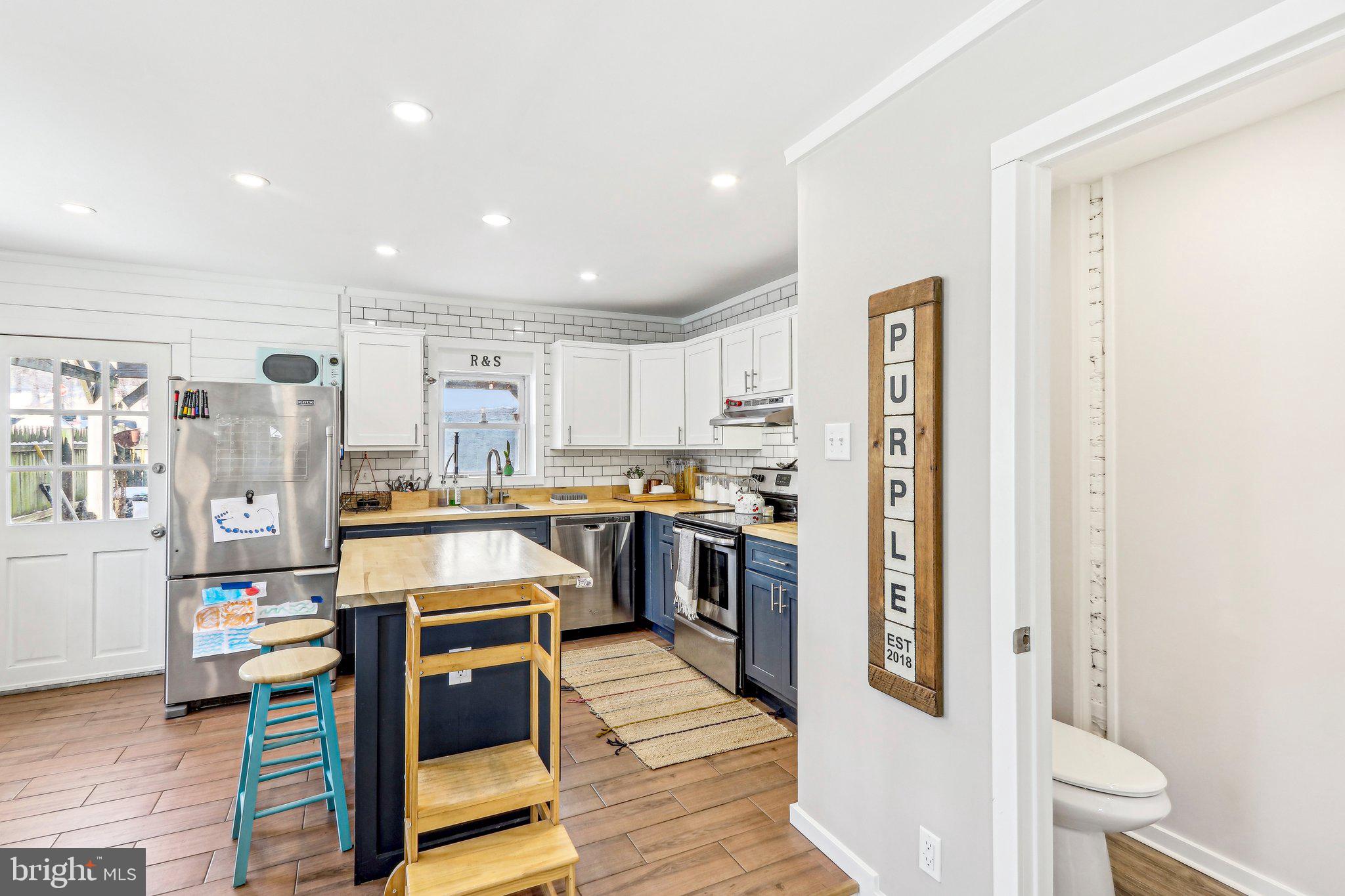456 Ripka Street Philadelphia, PA 19128 - Photo 7 of 29 a kitchen with stainless steel appliances granite countertop a refrigerator and a stove top oven