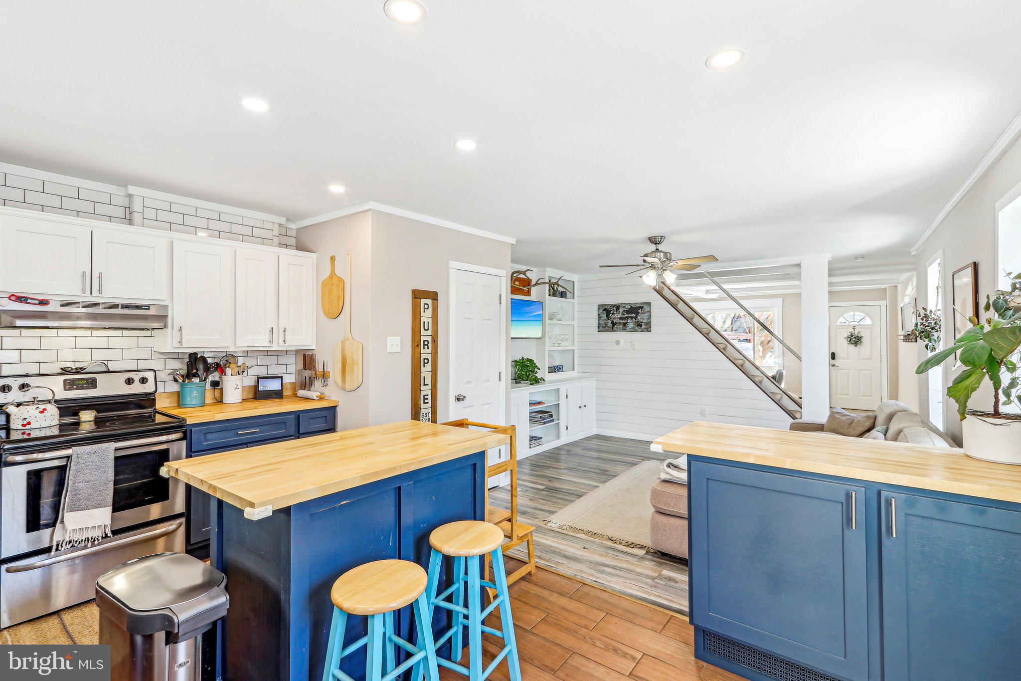 456 Ripka Street Philadelphia, PA 19128 - Photo 8 of 29 a kitchen with stainless steel appliances kitchen island granite countertop a table chairs in it and wooden floors
