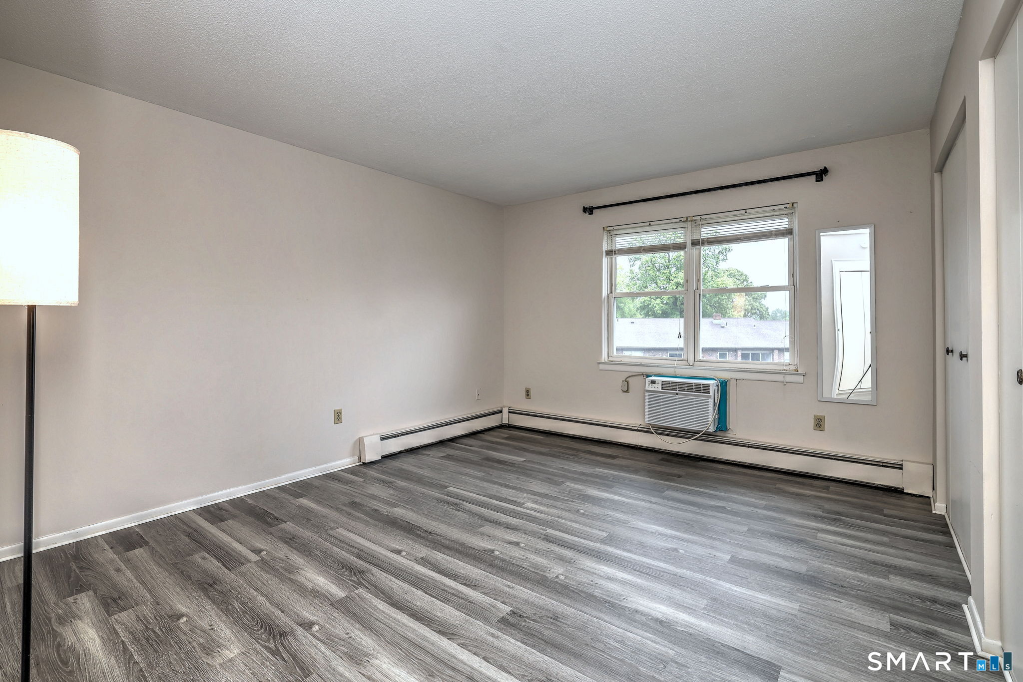 43 Balance Rock Road, Unit 11 Seymour, CT 06483 - Photo 31 of 40 an empty room with wooden floor and windows