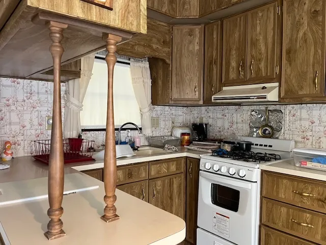 a kitchen with a sink stove and cabinets