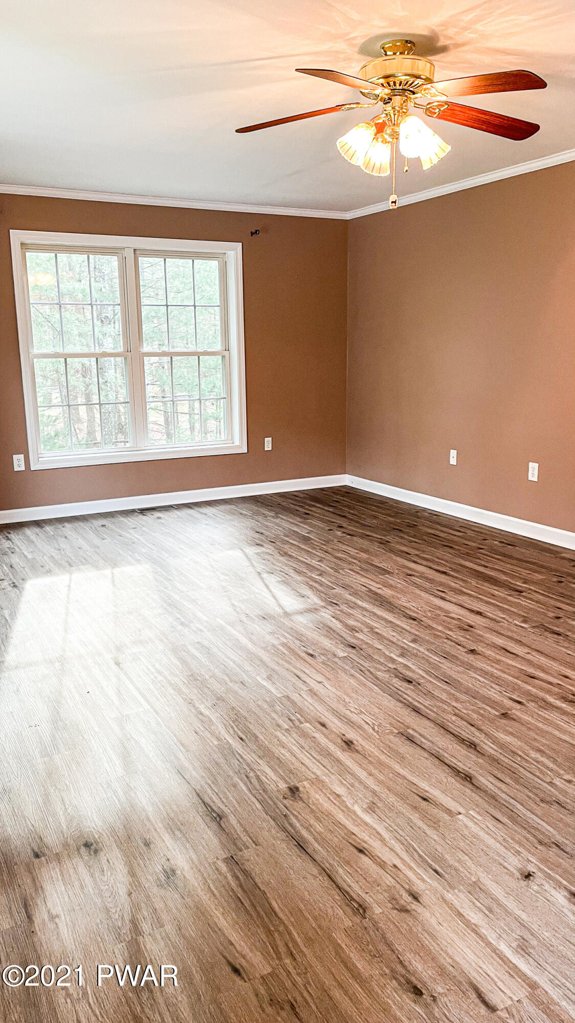 159 Fox Road Dingmans Ferry, PA 18328 - Photo 13 of 80 a view of an empty room with wooden floor and a window