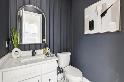 a bathroom with a toilet a sink and mirror