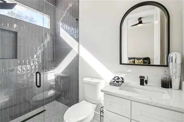 a bathroom with a sink a toilet and a mirror