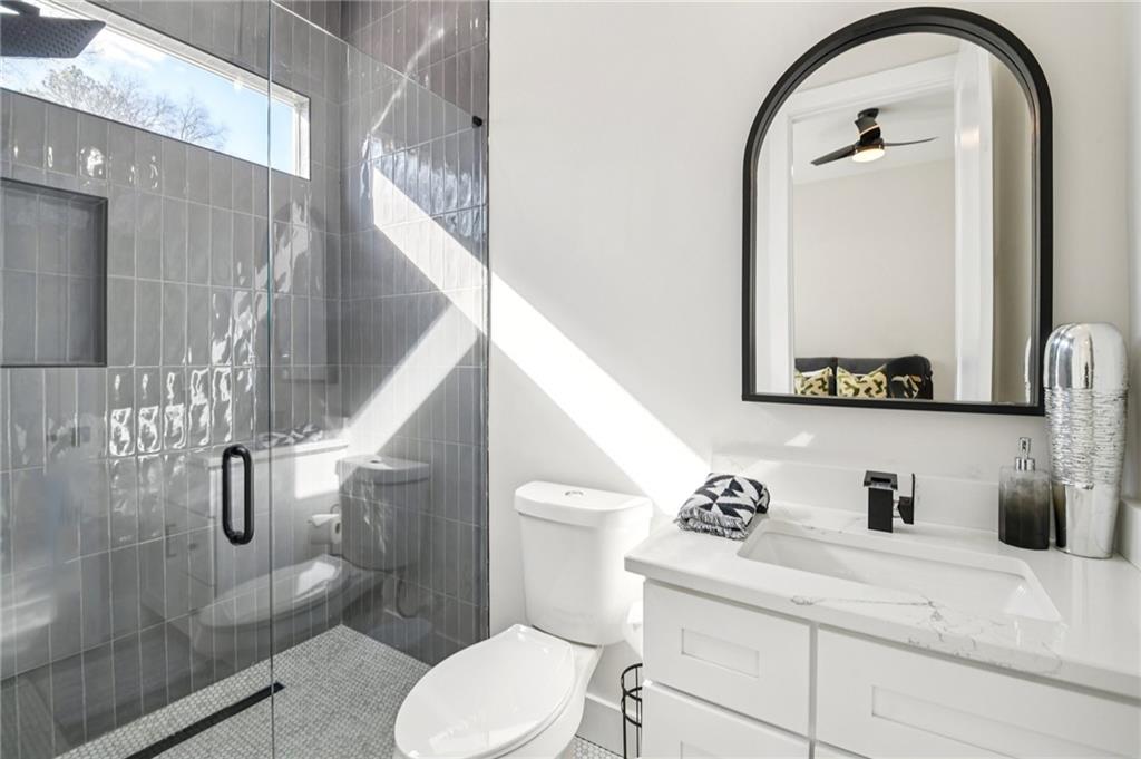 2014 Cambridge Avenue Atlanta, GA 30337 - Photo 16 of 34 a bathroom with a sink a toilet and a mirror