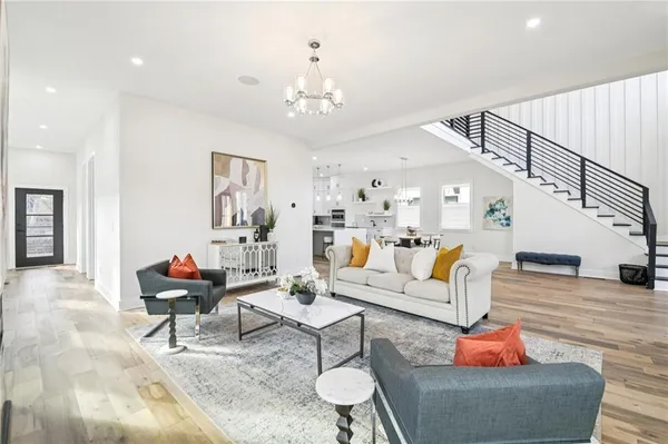 a living room with furniture and a chandelier